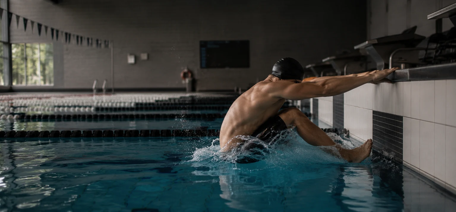 Louis Tucker pushing off the wall in a pool